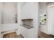 Convenient dog wash station with tiled backsplash, storage cabinets, and functional design at 1112 Valley Rose Way, Durham, NC 27712