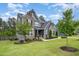 Charming two-story home with a lush lawn, stone accents, and a blend of gray siding for a modern appeal at 1112 Valley Rose Way, Durham, NC 27712
