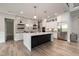 Modern kitchen with stainless steel appliances, a center island, and white cabinetry at 1112 Valley Rose Way, Durham, NC 27712