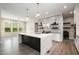 Modern kitchen with stainless steel appliances, waterfall island, and stylish backsplash at 1112 Valley Rose Way, Durham, NC 27712