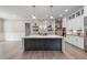 Modern kitchen with center island, stainless steel appliances, and open floor plan at 1112 Valley Rose Way, Durham, NC 27712