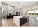 Modern kitchen with stainless steel appliances, an island, and an open floor plan at 1112 Valley Rose Way, Durham, NC 27712
