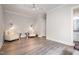 Bright living room featuring hardwood floors, modern sconces, and comfortable seating, perfect for relaxation at 1112 Valley Rose Way, Durham, NC 27712