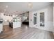 Open-concept living room and kitchen with hardwood floors and access to the backyard at 1112 Valley Rose Way, Durham, NC 27712
