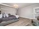 Luxurious main bedroom with a statement bed, a cozy seating area, and access to an outdoor balcony at 1112 Valley Rose Way, Durham, NC 27712