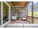 Relaxing screened-in porch with stone fireplace and seating for outdoor enjoyment at 1112 Valley Rose Way, Durham, NC 27712