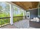 Inviting porch with wooded views, comfortable seating, a patterned rug and wood-planked ceiling at 1112 Valley Rose Way, Durham, NC 27712