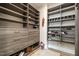 Bright walk-in closet featuring custom shelves and drawers for maximum storage and organization with wood floors at 1112 Valley Rose Way, Durham, NC 27712