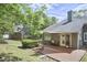Backyard deck with outdoor seating and shade sail, perfect for relaxation and enjoying the lush, green surroundings at 115 Standish Dr, Chapel Hill, NC 27517