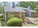 Cozy backyard featuring a wooden deck with outdoor seating and lush landscaping at 115 Standish Dr, Chapel Hill, NC 27517