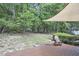 Spacious backyard with a deck and shade sail, offering a tranquil outdoor space to unwind and enjoy nature at 115 Standish Dr, Chapel Hill, NC 27517
