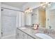Elegant bathroom featuring double sinks, granite countertops, and a tiled shower at 115 Standish Dr, Chapel Hill, NC 27517