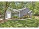 Attractive home with garage, complemented by green grass, manicured shrubbery, and lovely landscaping at 115 Standish Dr, Chapel Hill, NC 27517