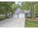 Charming home featuring a two-car garage, well-maintained lawn, and mature landscaping creating curb appeal at 115 Standish Dr, Chapel Hill, NC 27517