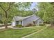 Well-maintained home with manicured lawn, mature trees, and charming landscaping, showcasing excellent curb appeal at 115 Standish Dr, Chapel Hill, NC 27517