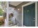 Charming front porch featuring hanging floral baskets and a stylish chair, creating a welcoming outdoor space at 115 Standish Dr, Chapel Hill, NC 27517