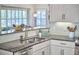 Bright kitchen featuring granite countertops, stainless steel appliances, and white cabinetry at 115 Standish Dr, Chapel Hill, NC 27517