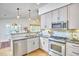 Modern kitchen featuring stainless steel appliances, granite countertops, and ample cabinetry at 115 Standish Dr, Chapel Hill, NC 27517