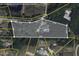 An aerial view of the property with a pool, showing its boundaries and proximity to Wood Lake Dr and surrounding wooded areas at 120 Wood Lake Dr, Fuquay Varina, NC 27526