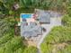 Aerial view of an estate with a pool, spa, large home, and a separate three-car garage at 120 Wood Lake Dr, Fuquay Varina, NC 27526