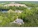 Overhead view of a secluded property with a pool, a main house, and a detached garage surrounded by trees at 120 Wood Lake Dr, Fuquay Varina, NC 27526