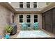 Inviting brick back porch with an outdoor table and grill overlooking the yard at 120 Wood Lake Dr, Fuquay Varina, NC 27526