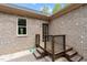 Back porch with wooden stairs, light brick, white gravel, and a door leading into the house at 120 Wood Lake Dr, Fuquay Varina, NC 27526