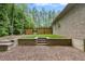 Backyard features a retaining wall, wood fence, and a storage door at 120 Wood Lake Dr, Fuquay Varina, NC 27526