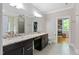 Bathroom with dual sinks, granite countertops, a walk-in shower, and a large mirror at 120 Wood Lake Dr, Fuquay Varina, NC 27526