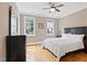 A bedroom featuring hardwood floors, crown molding, a ceiling fan, and two windows for plenty of natural light at 120 Wood Lake Dr, Fuquay Varina, NC 27526