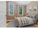 Cozy bedroom with a queen bed, two windows, hardwood floors, and neutral paint at 120 Wood Lake Dr, Fuquay Varina, NC 27526