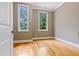 Bright bedroom with hardwood floors and two windows providing ample natural light at 120 Wood Lake Dr, Fuquay Varina, NC 27526