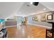 Open bonus room with hardwood floors, dart board decorations, and access to an outdoor porch at 120 Wood Lake Dr, Fuquay Varina, NC 27526