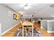Spacious bonus room features a wooden table, hardwood floors, and unique dart board decorations at 120 Wood Lake Dr, Fuquay Varina, NC 27526