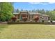 Inviting brick home featuring manicured landscaping and blooming bushes enhancing curb appeal at 120 Wood Lake Dr, Fuquay Varina, NC 27526