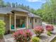 Charming front porch with brick detailing and vibrant landscaping enhancing curb appeal at 120 Wood Lake Dr, Fuquay Varina, NC 27526