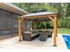 Gazebo with outdoor seating, rug, and a table next to a screened-in porch at 120 Wood Lake Dr, Fuquay Varina, NC 27526