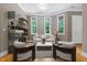Bright living room with large windows, stylish furnishings, and hardwood floors at 120 Wood Lake Dr, Fuquay Varina, NC 27526