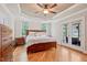 Main bedroom boasts hardwood floors, a tray ceiling, and french doors leading to a balcony at 120 Wood Lake Dr, Fuquay Varina, NC 27526