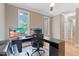 Spacious home office with hardwood floors, crown molding, ceiling fan, and large windows overlooking the backyard at 120 Wood Lake Dr, Fuquay Varina, NC 27526