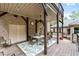 Spacious covered outdoor dining area with brick accents and stairs leading to yard at 120 Wood Lake Dr, Fuquay Varina, NC 27526
