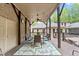 Inviting covered outdoor dining area with seating for six, ceiling fan, and outdoor lighting at 120 Wood Lake Dr, Fuquay Varina, NC 27526