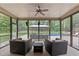 Enjoy the view of the backyard pool in this screened patio with comfortable seating and ceiling fan at 120 Wood Lake Dr, Fuquay Varina, NC 27526