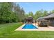 Luxurious backyard boasts a sparkling pool, gazebo, sundeck, and lush landscaping at 120 Wood Lake Dr, Fuquay Varina, NC 27526