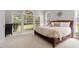 Comfortable bedroom featuring a large bed, soft carpet, and bright windows at 121 Cobblepoint Way, Holly Springs, NC 27540