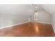 Large bonus room with hardwood floors and high ceilings provides versatile living space at 121 Cobblepoint Way, Holly Springs, NC 27540