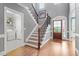 Grand foyer featuring hardwood floors, staircase with wood and wrought iron at 121 Cobblepoint Way, Holly Springs, NC 27540