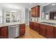Gourmet kitchen with stone countertops, stainless appliances, and wood cabinetry at 121 Cobblepoint Way, Holly Springs, NC 27540