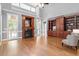 Open-concept living room with a fireplace, built-in cabinetry, and hardwood floors at 121 Cobblepoint Way, Holly Springs, NC 27540