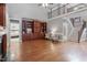 Open living room featuring a fireplace, built-in bookshelves, and hardwood floors at 121 Cobblepoint Way, Holly Springs, NC 27540